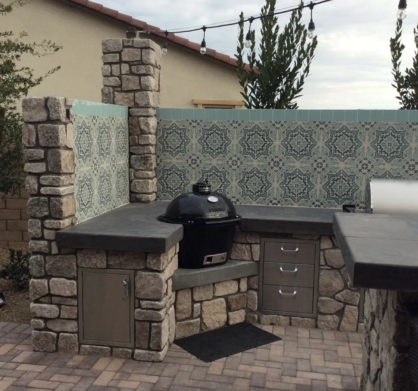 Stone BBQ island with built-in grill and outdoor kitchen