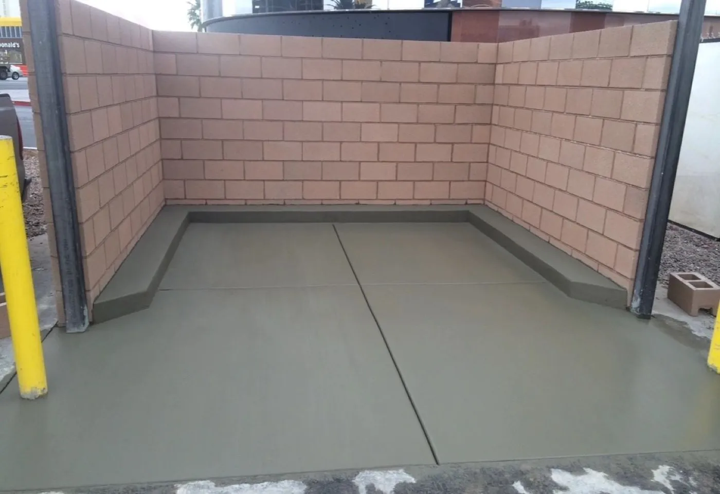 Commercial block enclosure with a fresh concrete slab