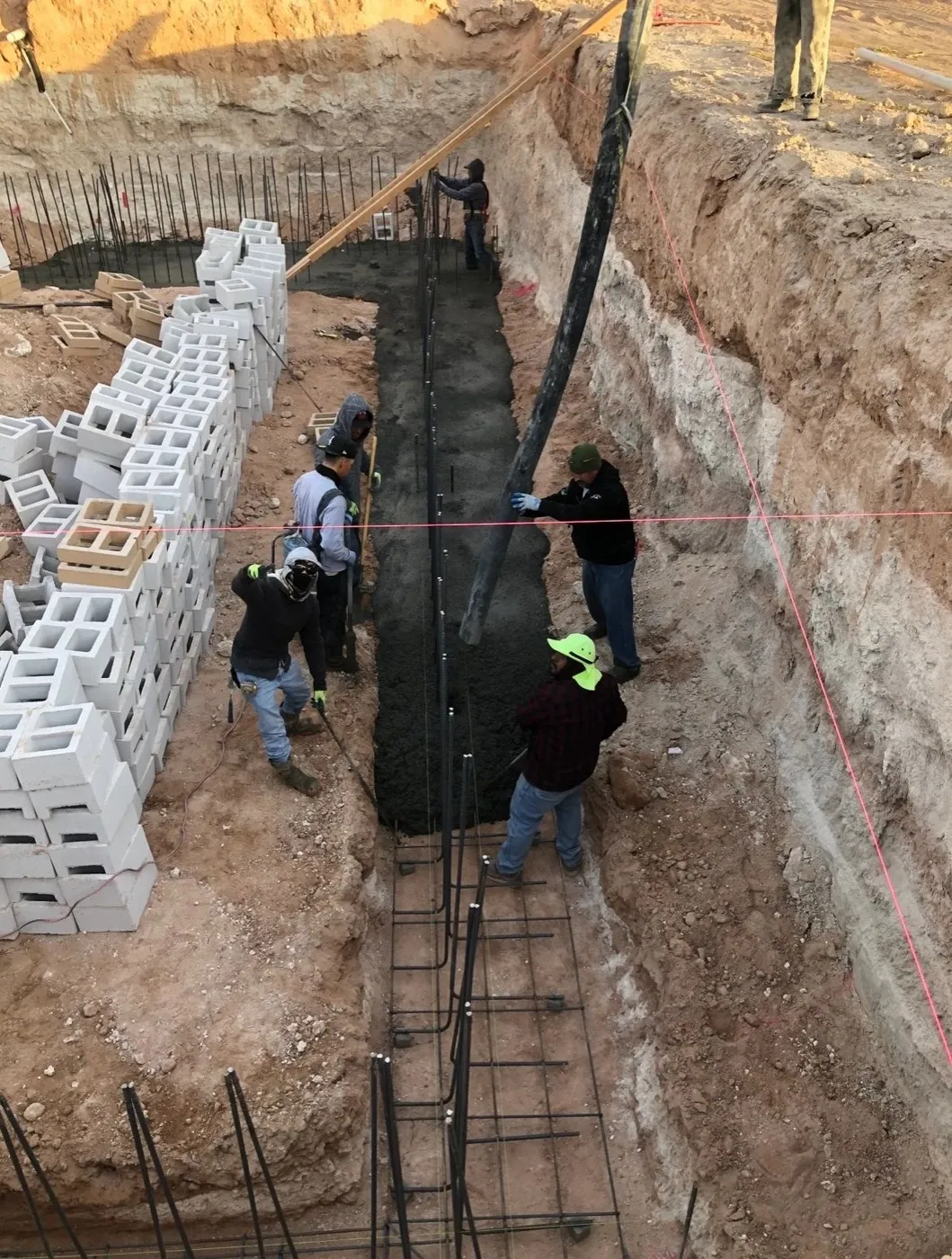 Crew forming and pouring a concrete footing