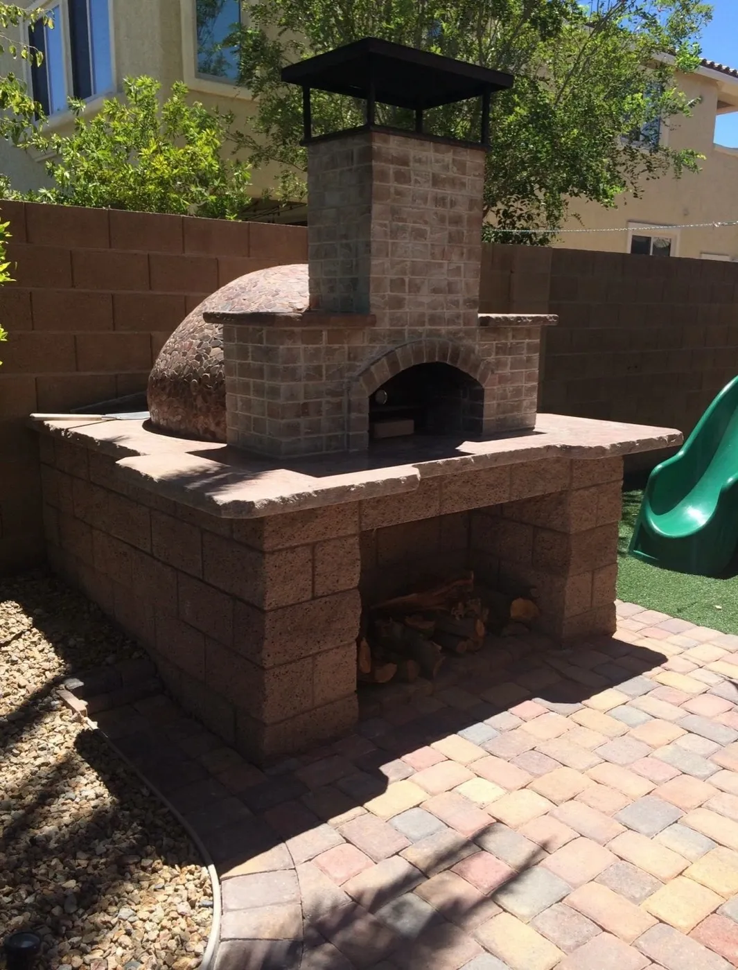 Wood fired pizza oven built on a paver patio
