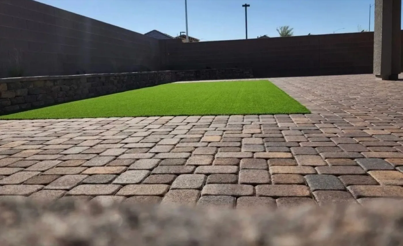Paver patio bordered with artificial turf