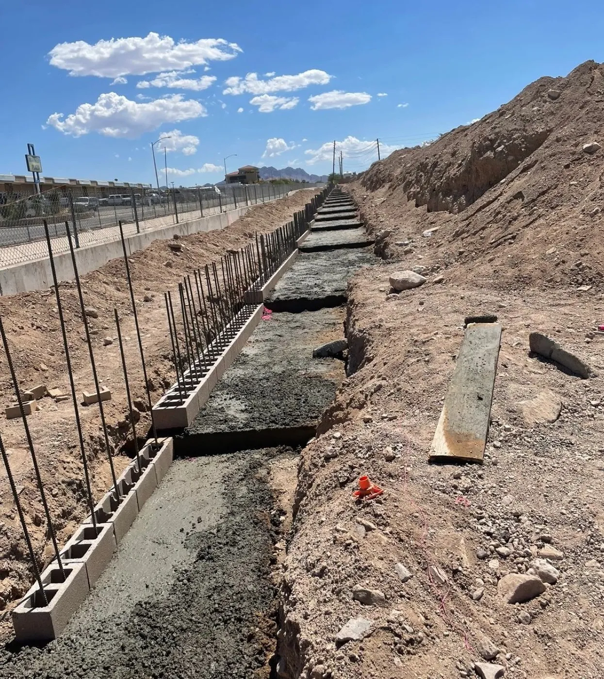 Sound wall footing with rebar along a highway corridor